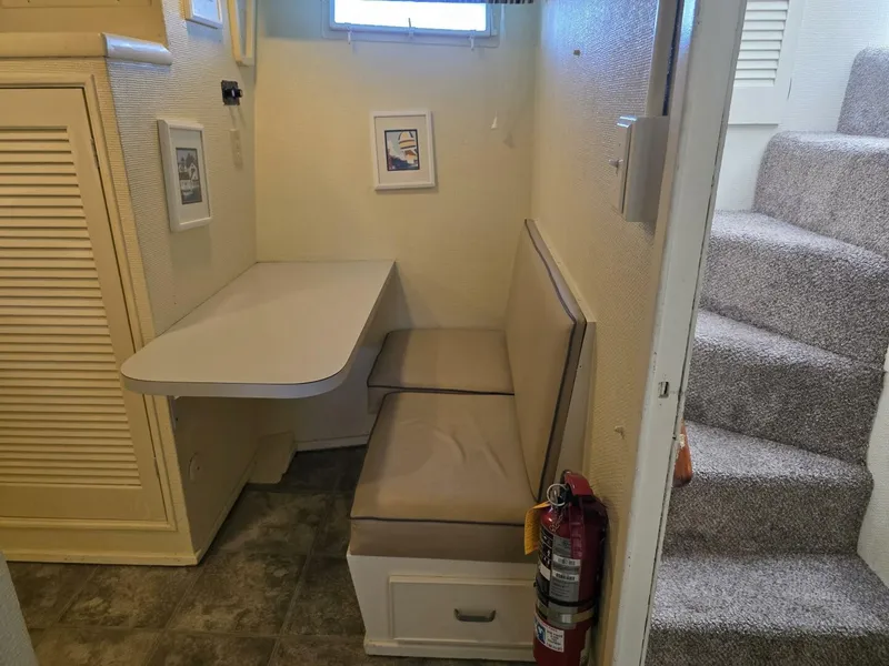 Slide: The Image of A cozy dining nook with cushioned seating and a table, next to a staircase. - 38