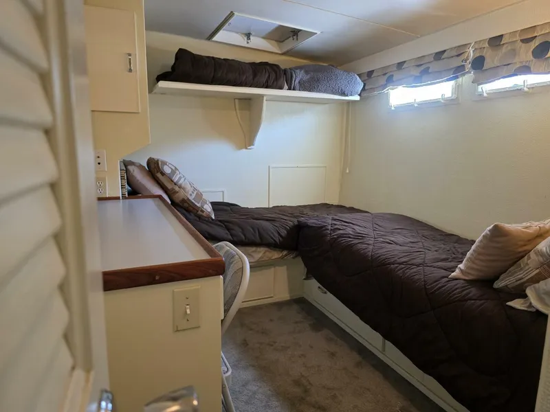 Slide: The Image of Interior of a 1976 Chris-Craft Roamer 60 with bunk beds and cozy furnishings. - 50