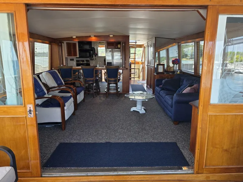 Slide: The Image of Interior of a 1976 Chris-Craft Roamer 60 with cozy seating and wooden accents. - 32