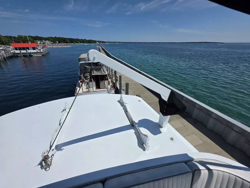 Slide: The Image of A 1976 Chris-Craft Roamer 60 docked, overlooking open water. - 23