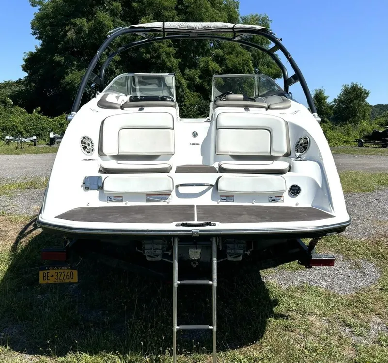 Slide: The Image of Rear view of a white Yamaha 242 Limited S boat with two seats and a swim ladder. - 4