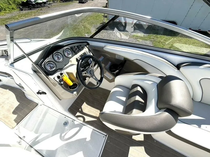 Slide: The Image of The image shows the cockpit of a 2013 Yamaha 242 Limited S boat with a sleek helm. - 19