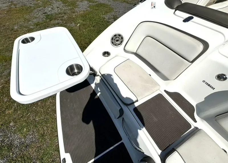 Slide: The Image of The image shows the stern of a Yamaha 242 Limited S boat with a fold-out table. - 12