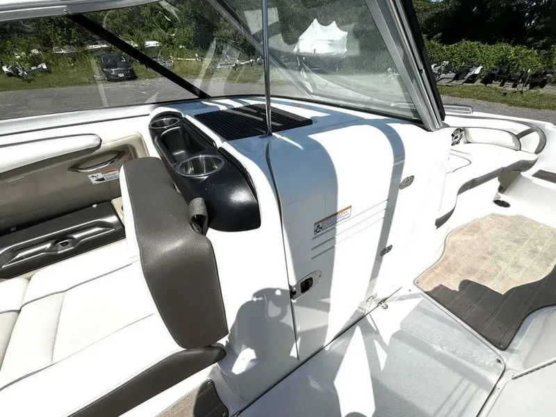 Slide: The Image of The image shows the cockpit of a 2013 Yamaha 242 Limited S boat with white and brown seating. - 29