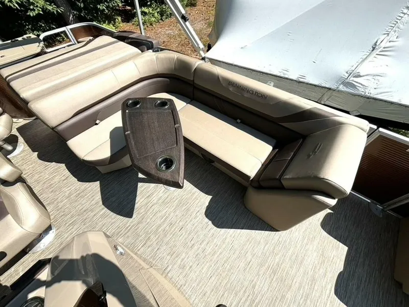 Slide: The Image of Interior of a Bennington 21 SXSAPG pontoon boat with beige and brown seating and a table. - 16