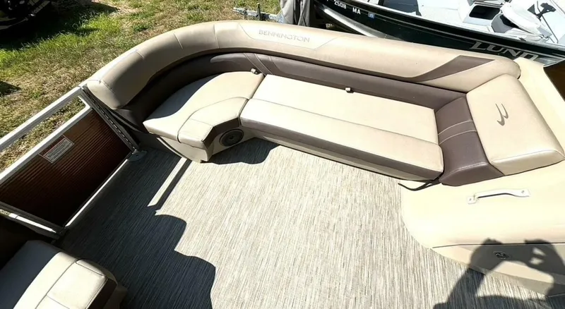 Slide: The Image of The image shows the seating area of a Bennington 21 SXSAPG pontoon boat with beige and brown upholstery. - 24