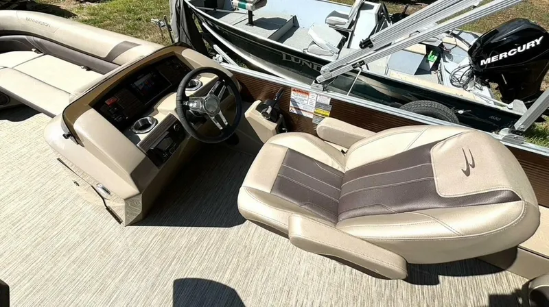 Slide: The Image of The image shows the cockpit of a 2023 Bennington 21 SXSAPG with a comfortable helm seat. - 17