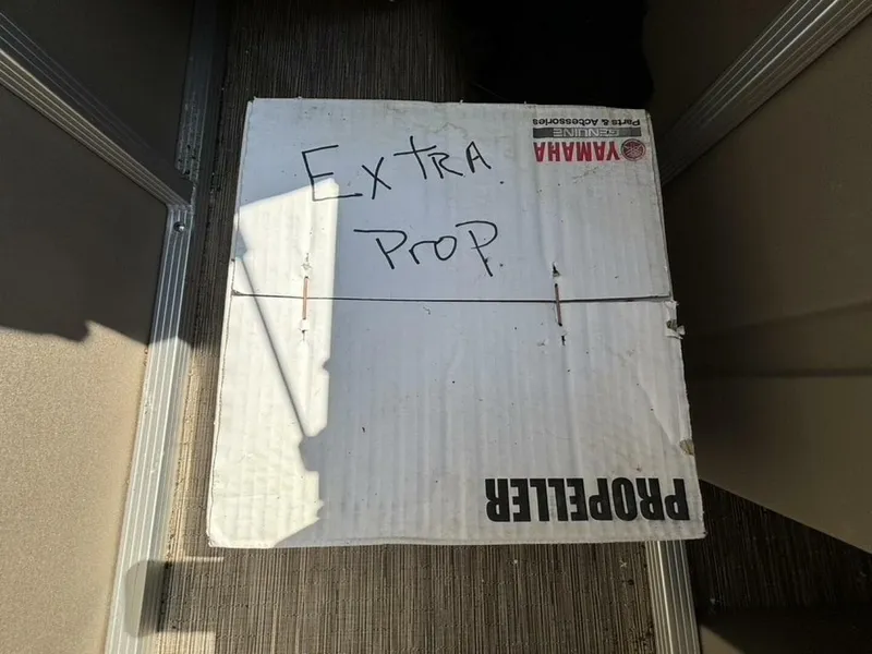 Slide: The Image of A box labeled "Extra Prop" is on the floor of a boat. - 35