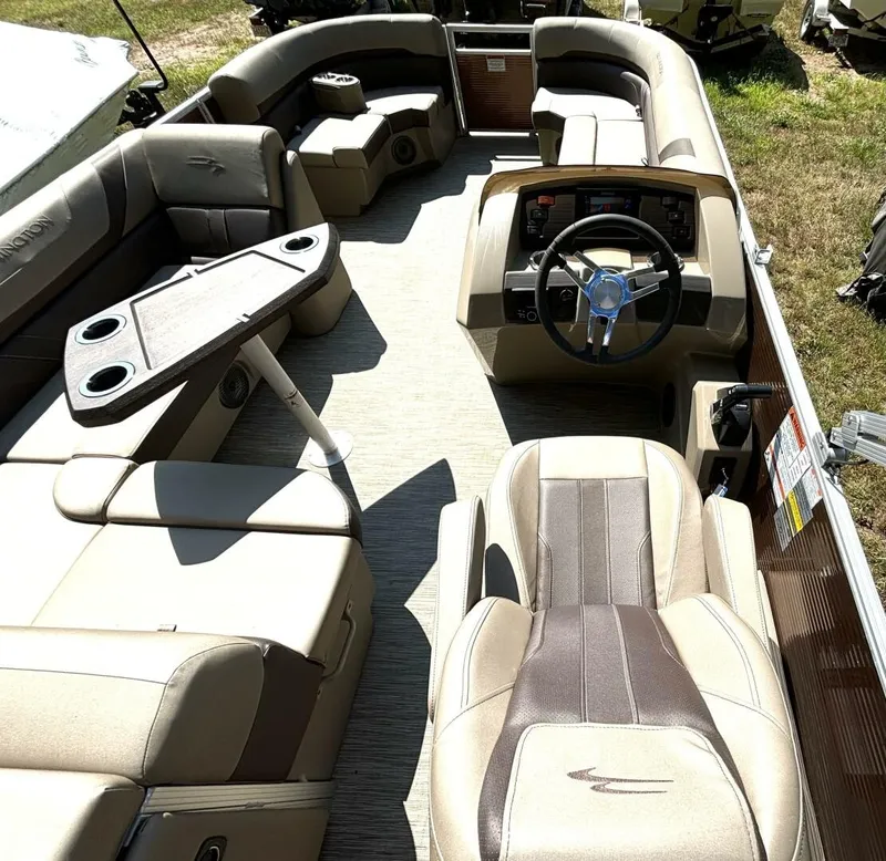 Slide: The Image of Interior of a 2023 Bennington 21 SXSAPG pontoon boat with beige upholstery and a modern helm. - 18