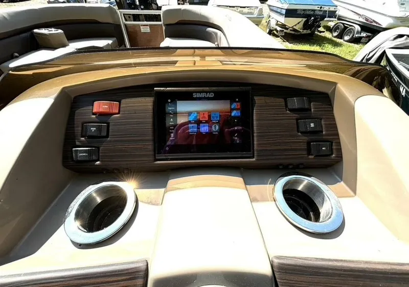 Slide: The Image of The image shows the dashboard of a 2023 Bennington 21 SXSAPG with a Simrad display. - 21