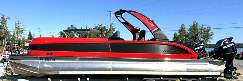The Image of A red 2022 Manitou XT 27 SRW pontoon boat with dual outboard engines. - 1