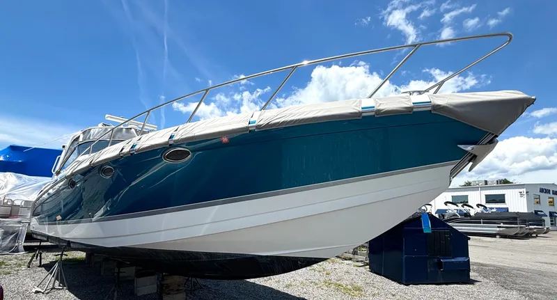 Slide: The Image of A 2006 Formula 400 Super Sport with a blue hull and cover, on a dry dock. - 4