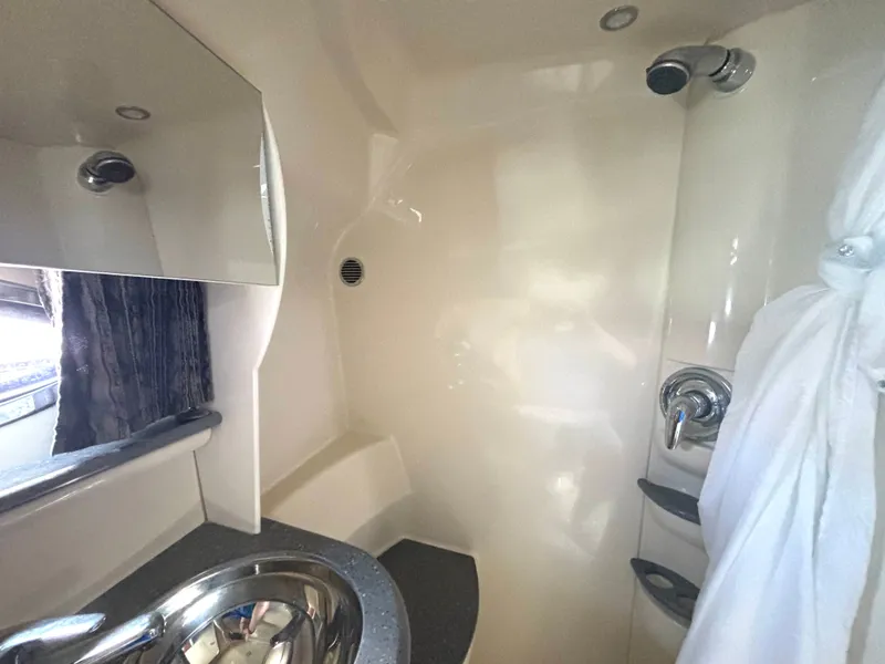 Slide: The Image of The image shows a modern boat bathroom with a sink and shower. - 50