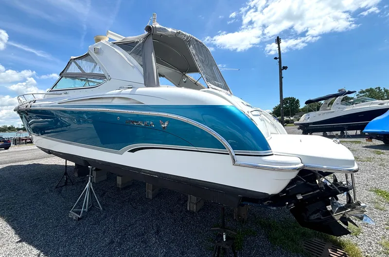 Slide: The Image of A 2006 Formula 400 Super Sport on dry dock, featuring blue and white paint with a clear cover. - 8