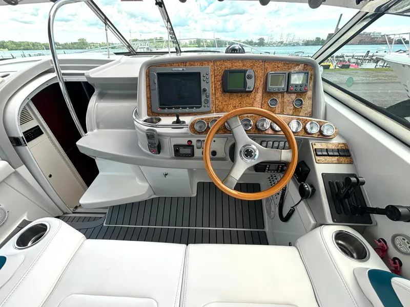 Slide: The Image of The cockpit of a 2006 Formula 400 Super Sport with a wooden steering wheel and modern instruments. - 27