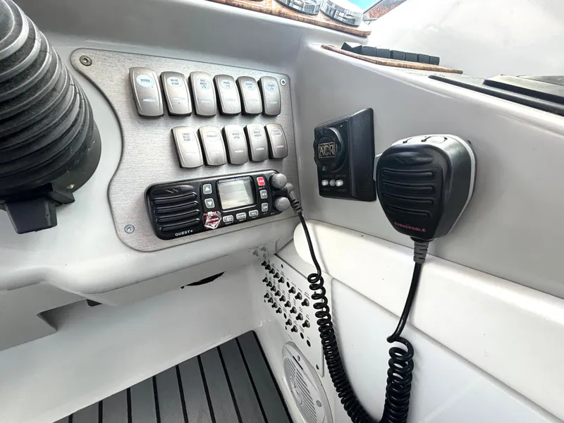 Slide: The Image of The image shows a boat's dashboard with switches and a radio. - 31