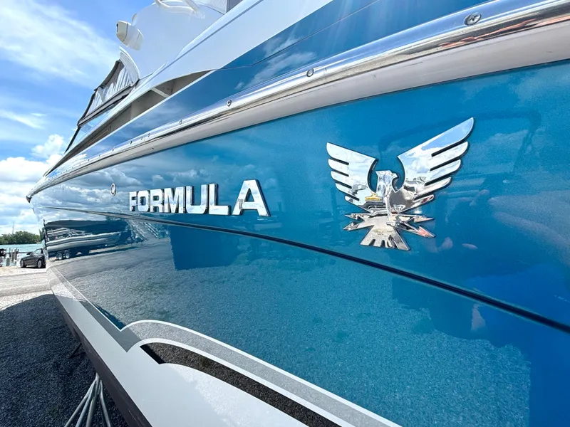 Slide: The Image of Side view of a blue 2006 Formula 400 Super Sport with a shiny logo. - 9