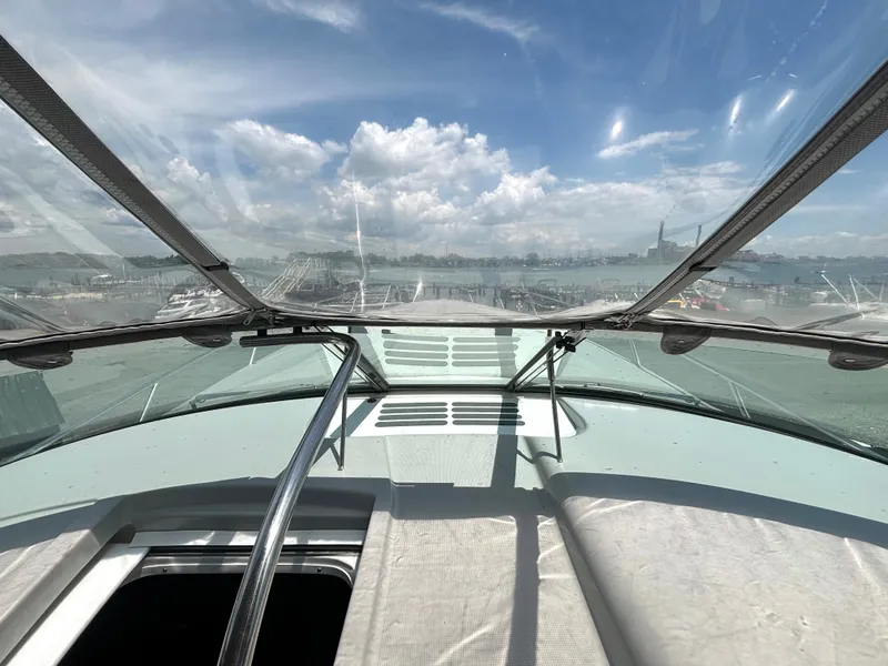 Slide: The Image of View from the helm of a 2006 Formula 400 Super Sport overlooking a harbor under a blue sky. - 32