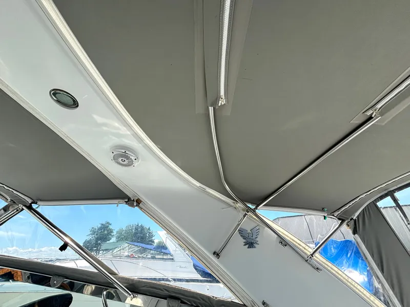 Slide: The Image of The image shows a boat's canopy with metal supports and a speaker. - 34