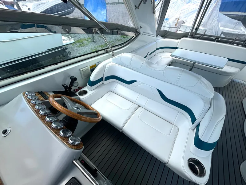 Slide: The Image of The image shows the cockpit of a 2006 Formula 400 Super Sport with white leather seats and a wood-trimmed steering wheel. - 26