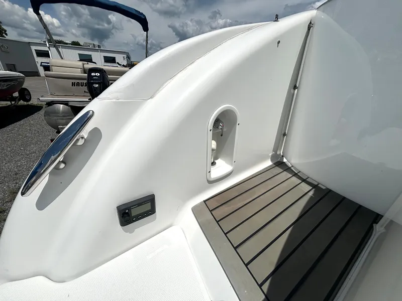 Slide: The Image of The image shows the stern of a boat with a smooth white surface and wooden flooring. - 17