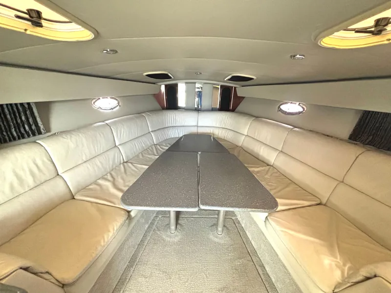 Slide: The Image of Interior of a 2006 Formula 400 Super Sport with beige leather seating and a gray table. - 40
