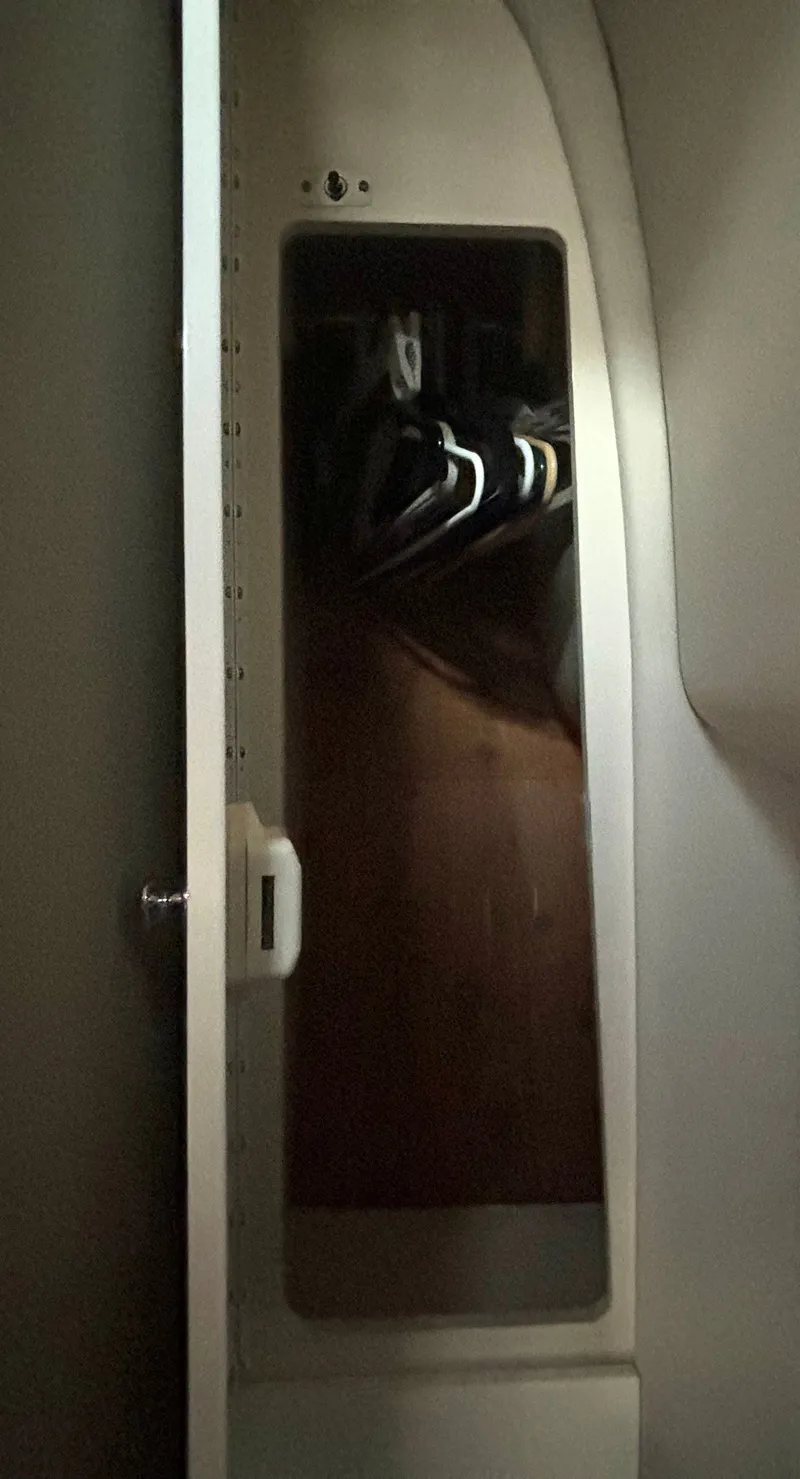 Slide: The Image of A closet with hangers inside a boat. - 48
