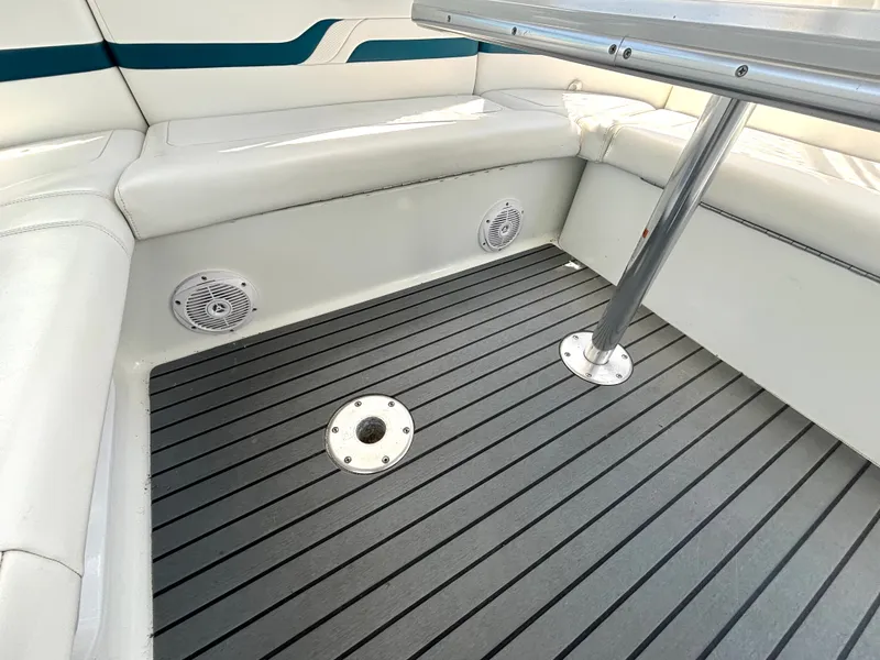 Slide: The Image of The image shows a boat seating area with white upholstery and a table. - 20