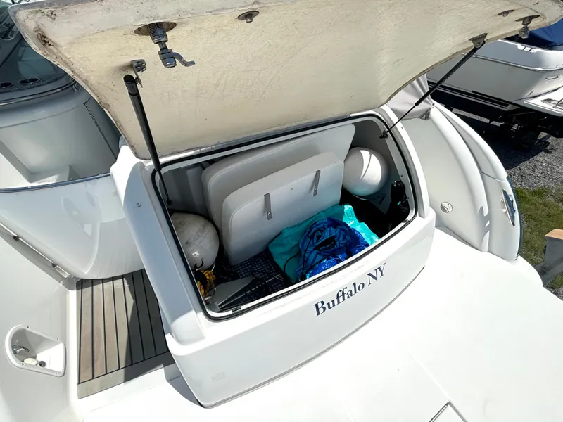 Slide: The Image of An open storage compartment on a boat with life rings and a blue towel. - 15