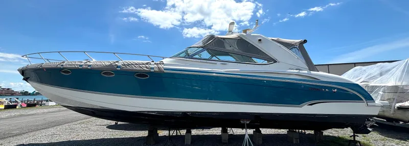 The Image of A 2006 Formula 400 Super Sport with a blue hull is on a dry dock. - 1