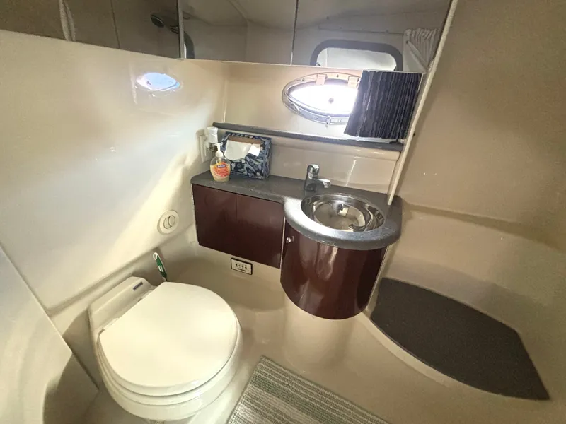 Slide: The Image of The image shows the bathroom of a 2006 Formula 400 Super Sport with a toilet, sink, and mirror. - 49