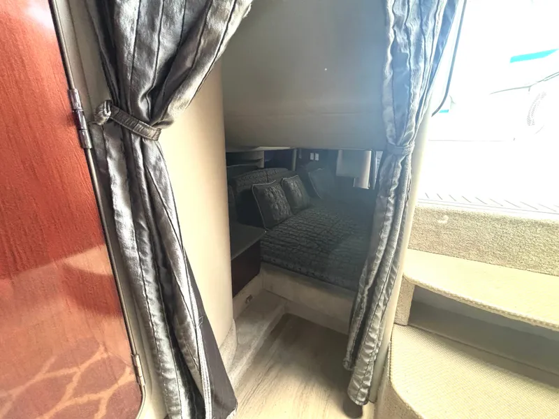 Slide: The Image of A cozy sleeping area with curtains and pillows inside a boat. - 44