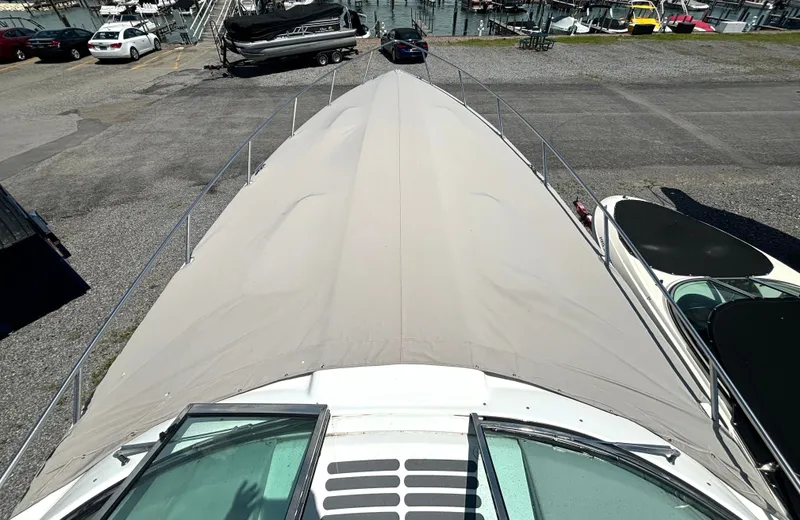 Slide: The Image of A covered boat in a parking area, surrounded by other boats and trailers. - 11
