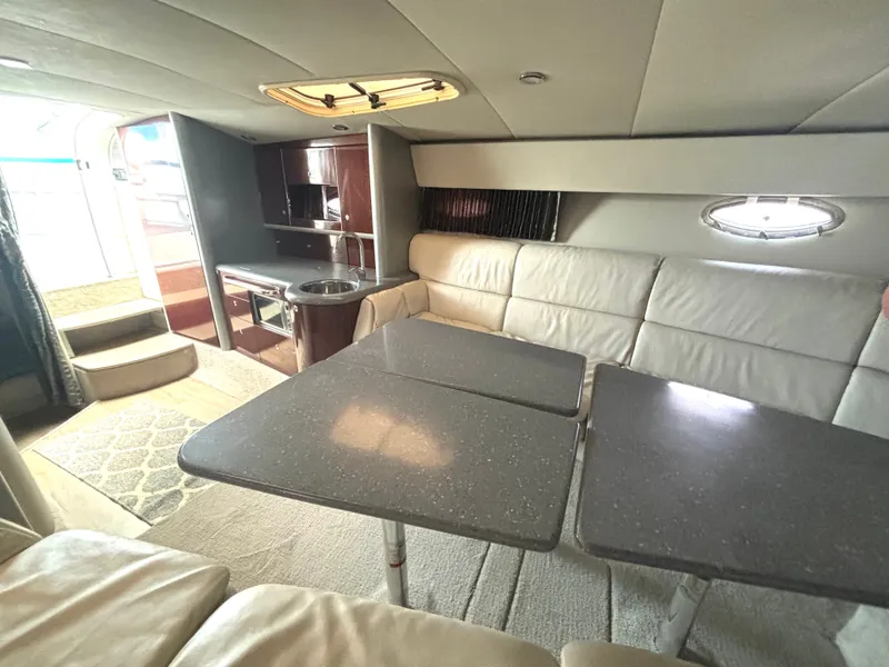 Slide: The Image of Interior of a 2006 Formula 400 Super Sport with beige sofa, dining table, and kitchenette. - 43
