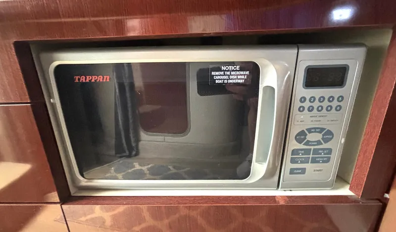 Slide: The Image of Microwave in a boat, built into a wooden cabinet. Control panel and Tappan logo visible. - 39