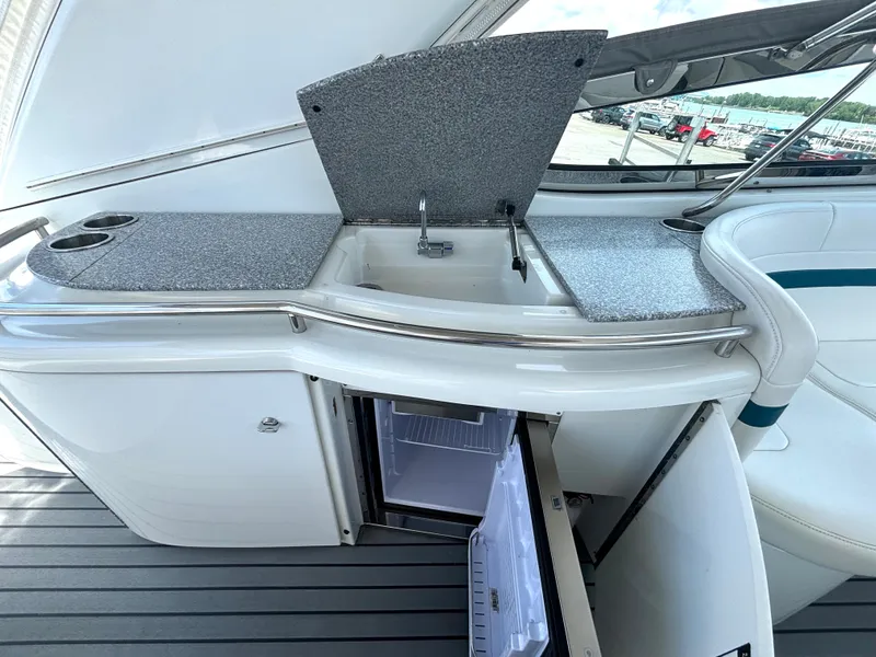 Slide: The Image of The 2006 Formula 400 Super Sport features an outdoor galley with a sink, refrigerator, and storage. - 22