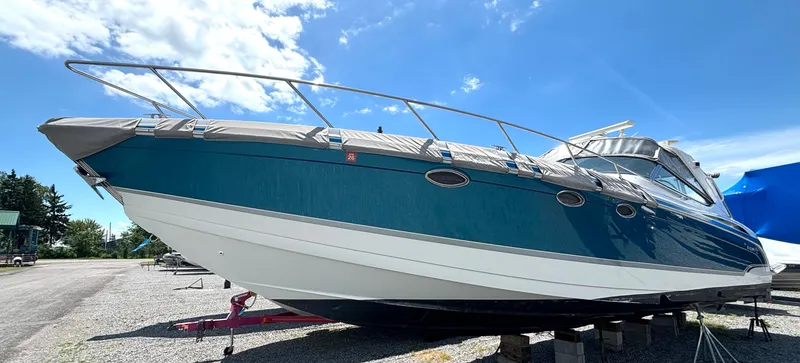 Slide: The Image of A 2006 Formula 400 Super Sport with a blue hull is on a dry dock. - 2