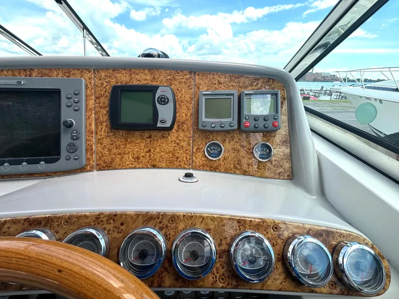 Slide: The Image of The dashboard of a 2006 Formula 400 Super Sport with wood accents and multiple instruments. - 29