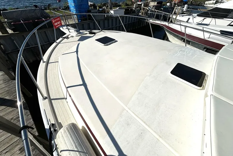 Slide: The Image of The image shows the deck of a 1987 Viking Motor Yacht docked at a marina. - 10