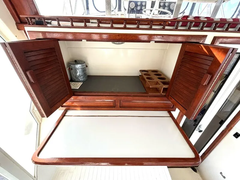 Slide: The Image of Interior of a 1987 Viking Motor Yacht with wooden cabinetry and storage space. - 24