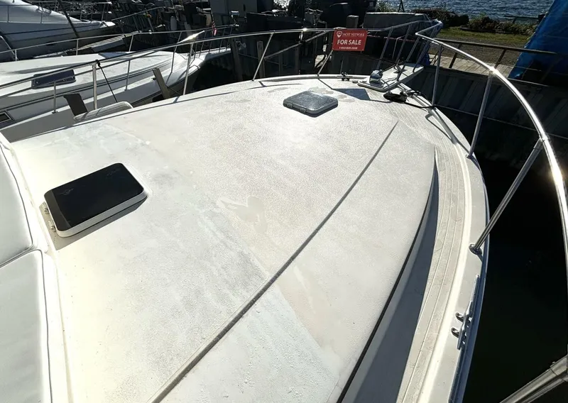Slide: The Image of The image shows the deck of a 1987 Viking Motor Yacht with a "For Sale" sign. - 13