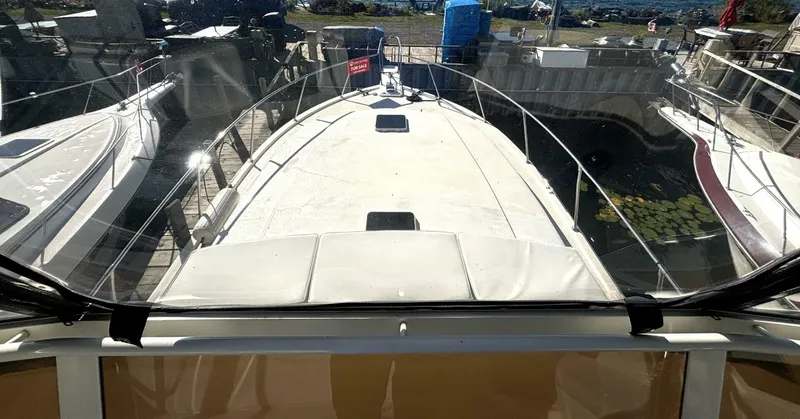 Slide: The Image of View from the bridge of a 1987 Viking Motor Yacht overlooking the foredeck, surrounded by other boats. - 37