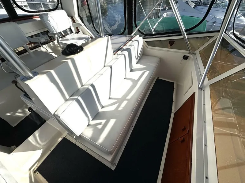 Slide: The Image of The image shows the cockpit of a 1987 Viking Motor Yacht with white upholstery. - 35