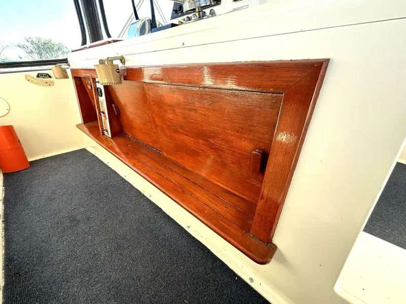 Slide: The Image of Wood-paneled helm station on a 1987 Viking Motor Yacht. - 34