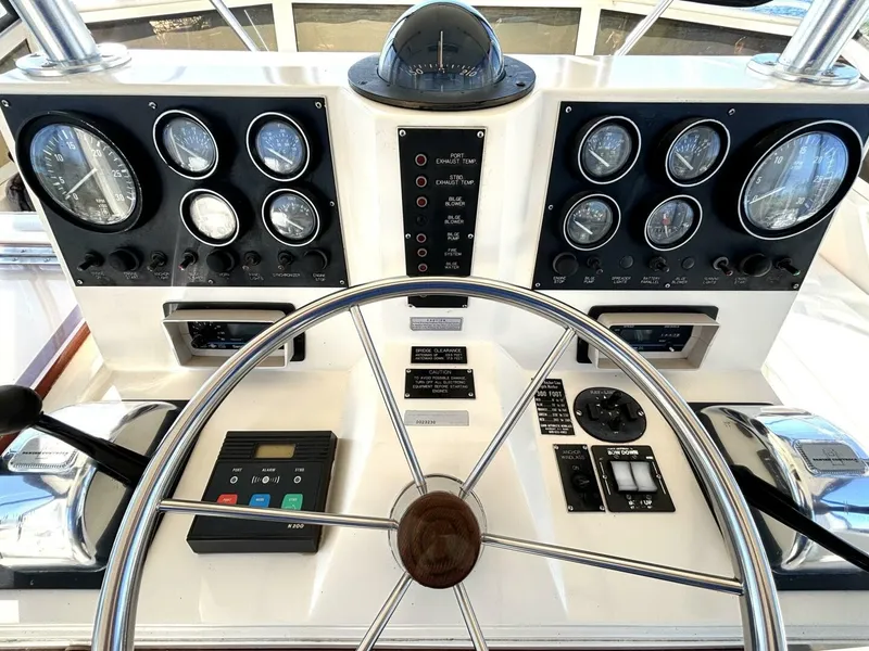 Slide: The Image of The image shows the helm of a 1987 Viking Motor Yacht with numerous gauges and a steering wheel. - 30