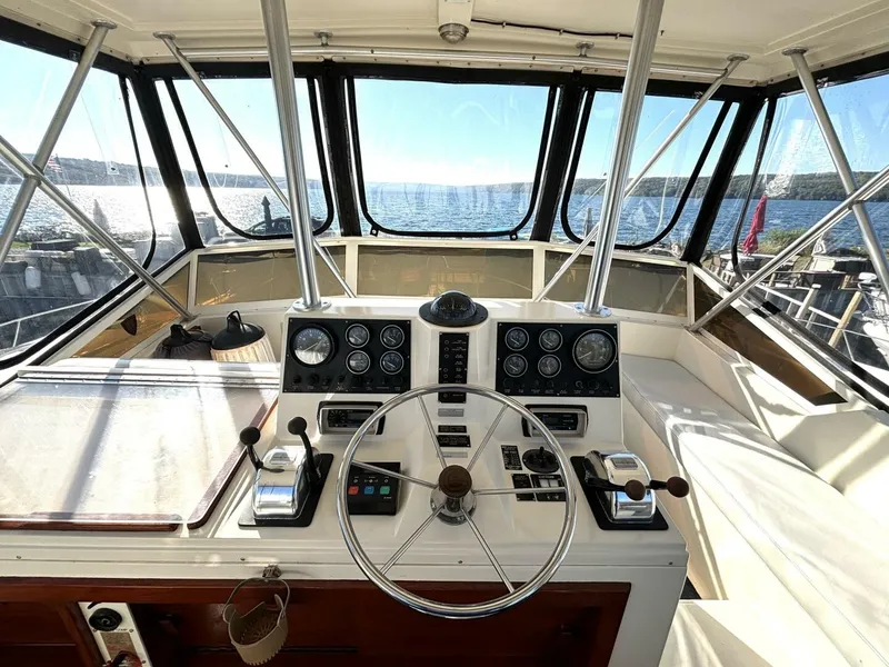 Slide: The Image of The image shows the helm of a 1987 Viking Motor Yacht with a panoramic view of the water. - 29