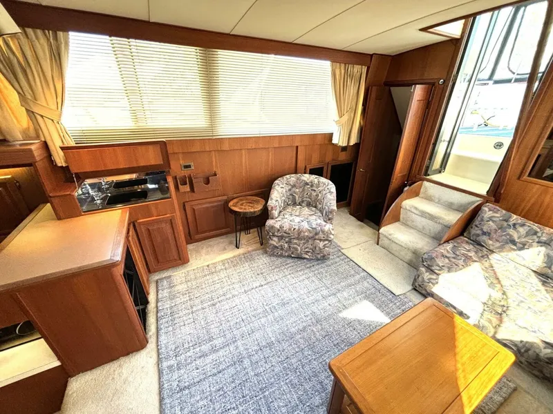 Slide: The Image of Interior of a 1987 Viking Motor Yacht with wooden furnishings and cozy seating. - 44