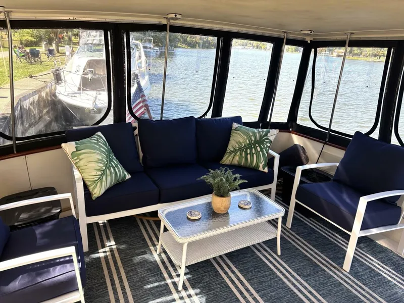 Slide: The Image of The image shows a yacht interior with blue cushions and a table. - 21