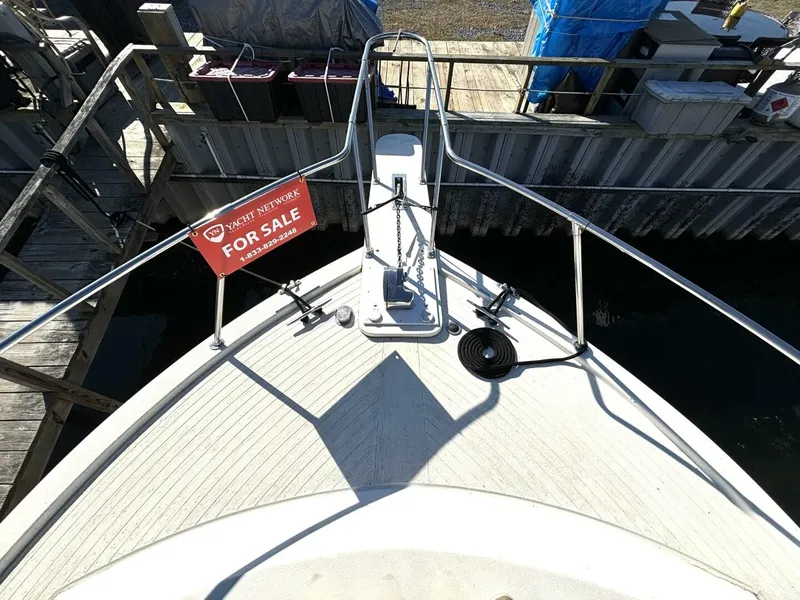 Slide: The Image of 1987 Viking Motor Yacht with a for sale sign on the bow, docked at a pier. - 11