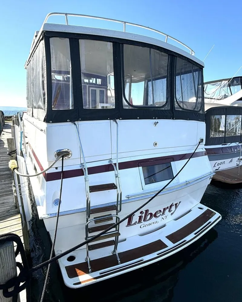 Slide: The Image of A 1987 Viking Motor Yacht docked, featuring a white hull and covered upper deck. - 7